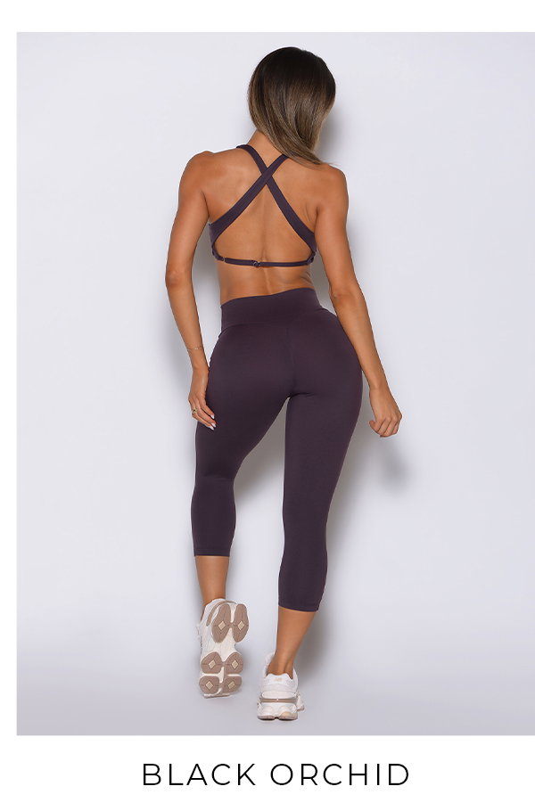 Model wearing Ace Sports Bra and Smooth Capri Leggings in Black Orchid