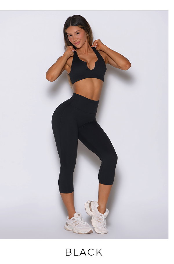 Model wearing Ace Sports Bra and Smooth Capri Leggings in Black