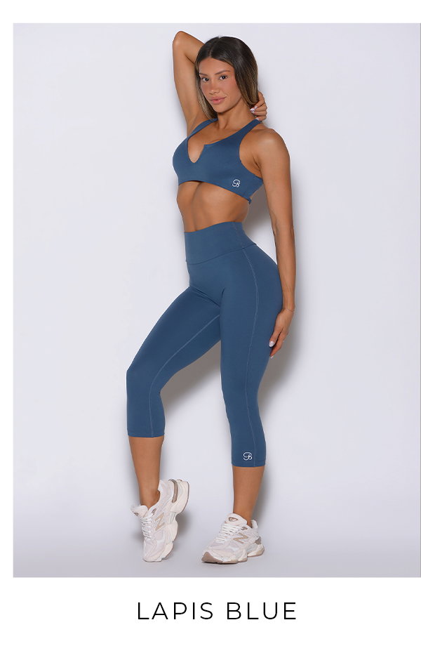 Model wearing Ace Sports Bra and Smooth Capri Leggings in Lapis Blue