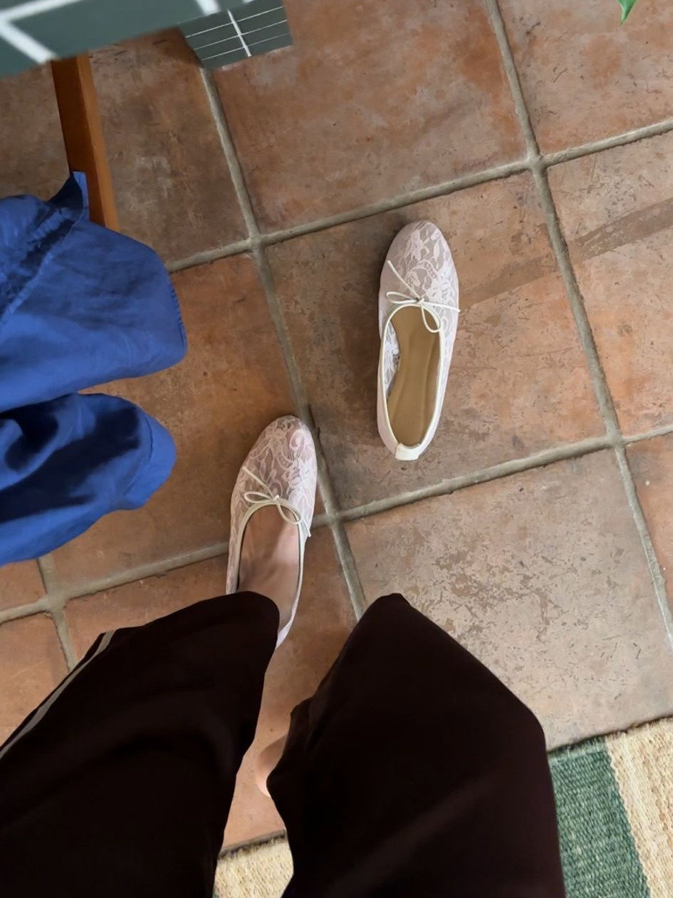 woman wears white lace ballerina shoes