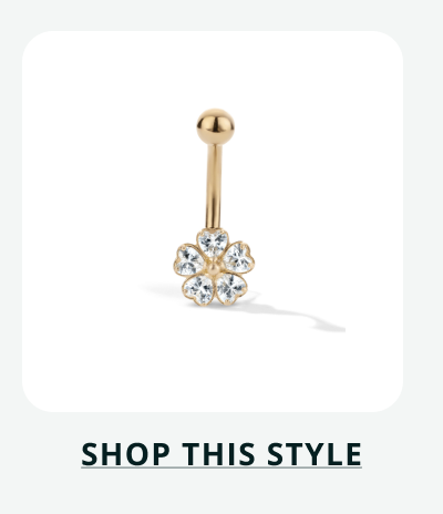 Gold barbell featuring a fixed clear gemstone flower cluster at the base. Click here to shop this style
