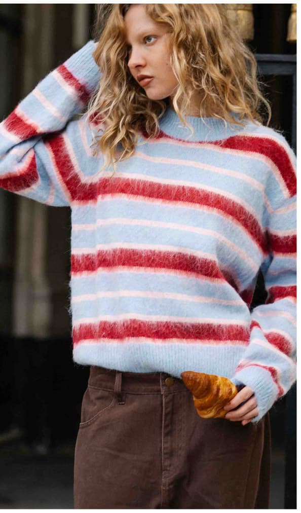Brown barrel leg jeans paired with a baby blue, red and pink strip jumper