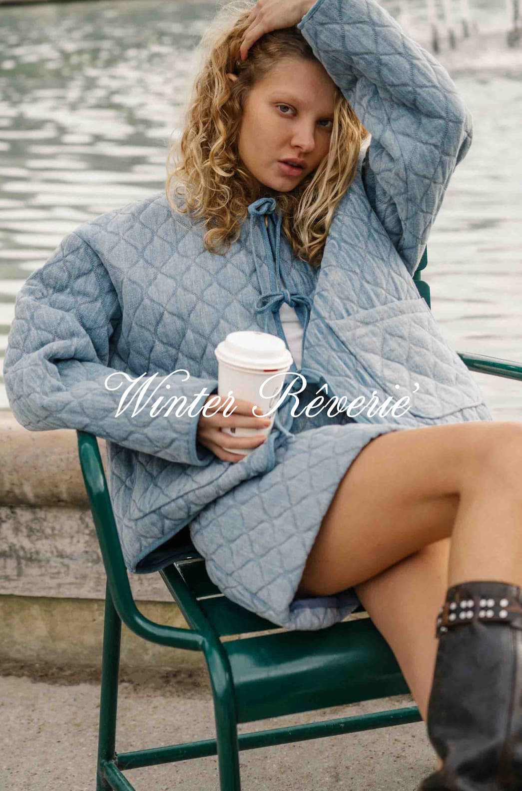 model wears a qulted denim jacket and skirt sitting by a pond in paris