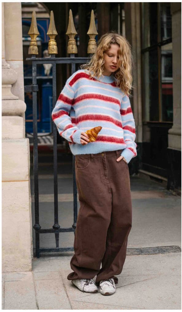 Brown barrel leg jeans paired with a baby blue, red and pink strip jumper