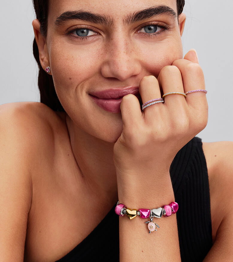 Model wearing a tonal pink styling, featuring the turtle charm