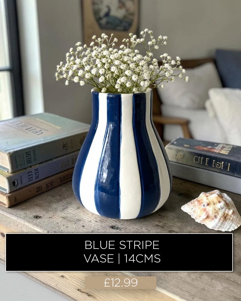 Blue striped ceramic vase with white flowers