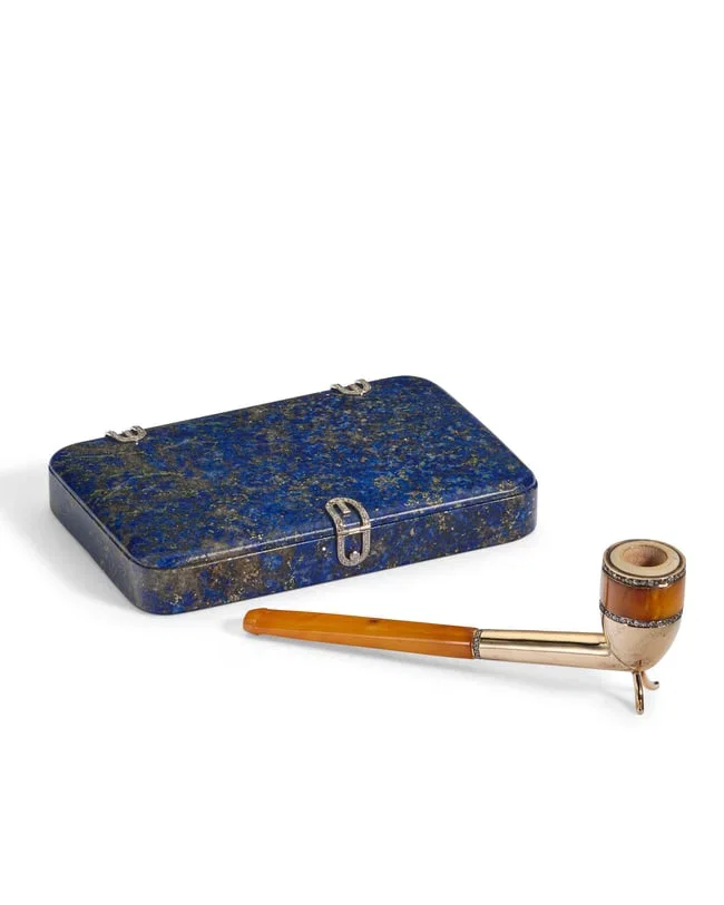 A CONTINENTAL DIAMOND AND PLATINUM-MOUNTED LAPIS LAZULI CIGARETTE CASE AND GOLD-MOUNTED AMBER PIPE