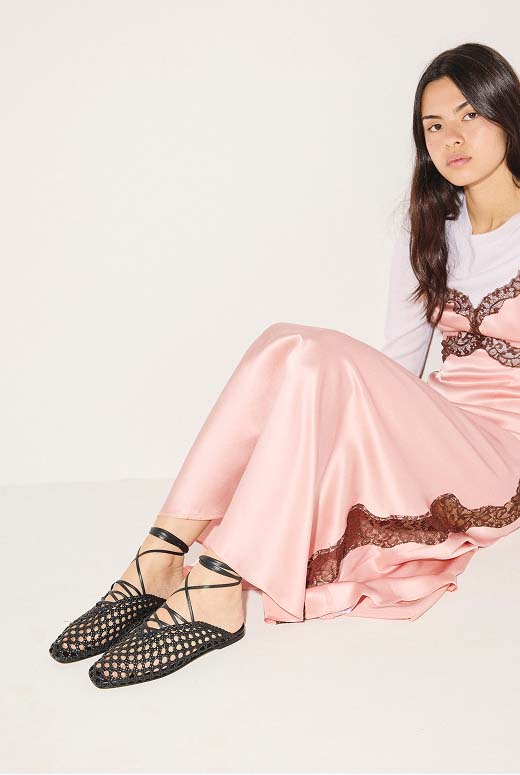 ETTA woven flat in black calf styled with a pink satin lace-trim slip dress and a white long-sleeve t-shirt.
