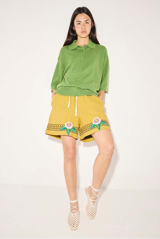 ETTA woven flat in Vanilla styled with a green polo shirt and yellow embroidered shorts.