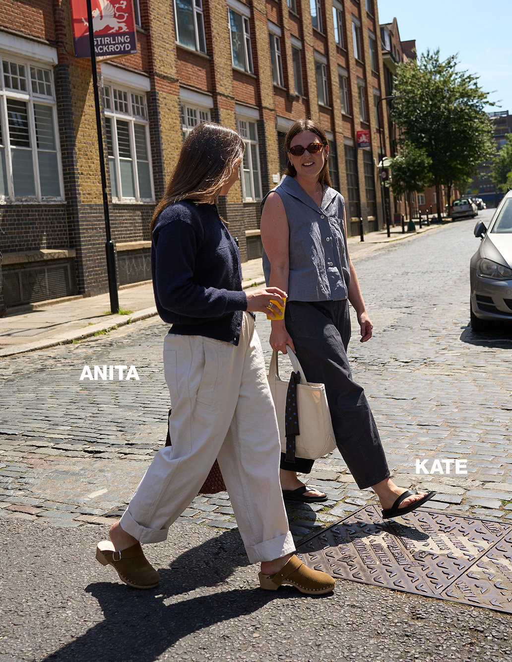 Two women in summer clothes talking in the street.