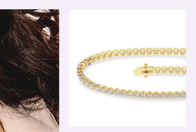 A gold diamond tennis bracelet.