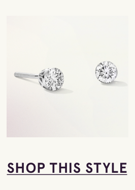 A pair of white metal diamond stud earrings. Click here to shop this style