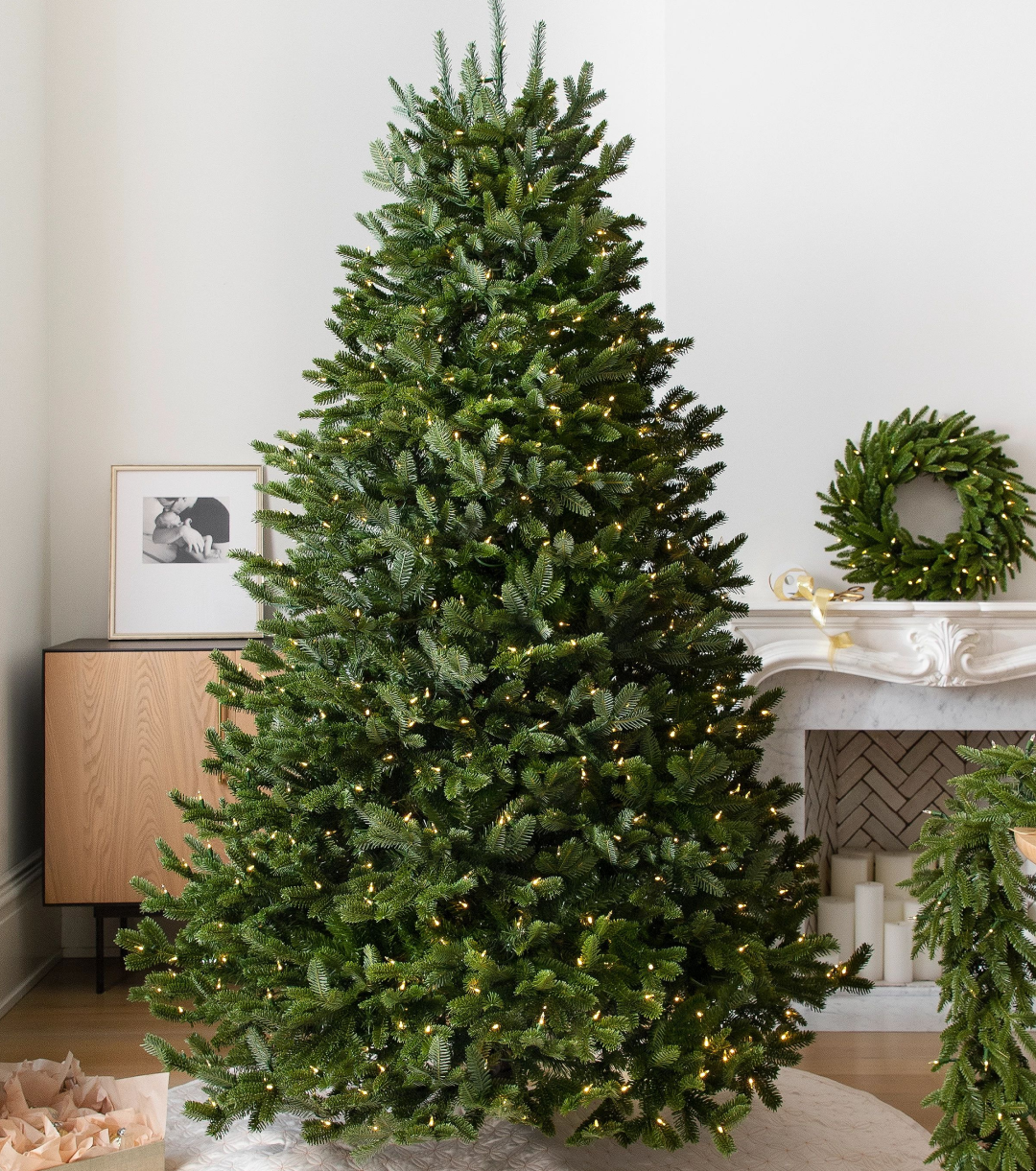 An unlit Christmas tree with a front room background