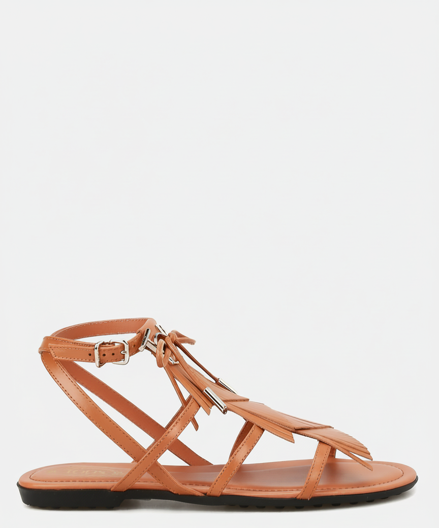 A brown leather gladiator sandal with fringe detailing and a buckle ankle strap.