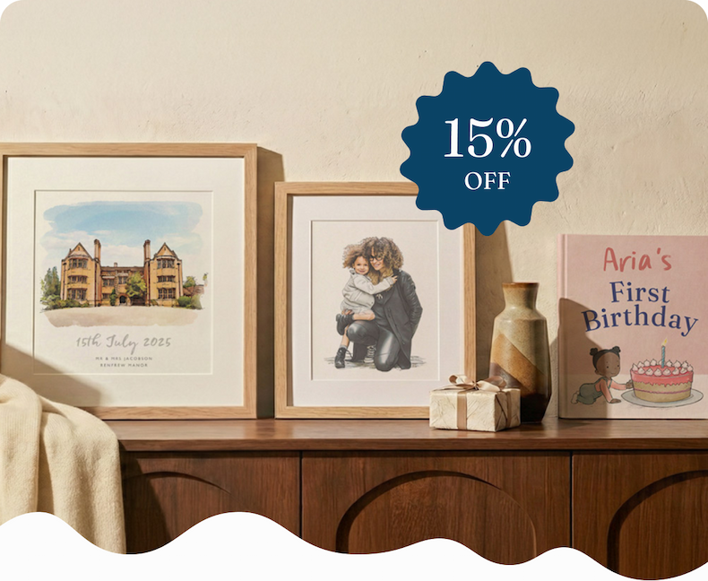 A sideboard displaying three personalised Letterfest gifts — a framed watercolour illustration of a house, a framed portrait of a parent and child, and a personalised first birthday book titled "Aria's First Birthday"