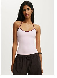 Woman wearing lavender camisole and black shorts