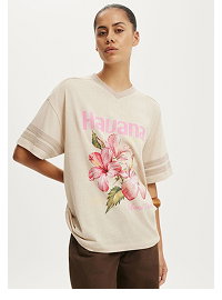 Cream floral graphic t-shirt with striped sleeves on model