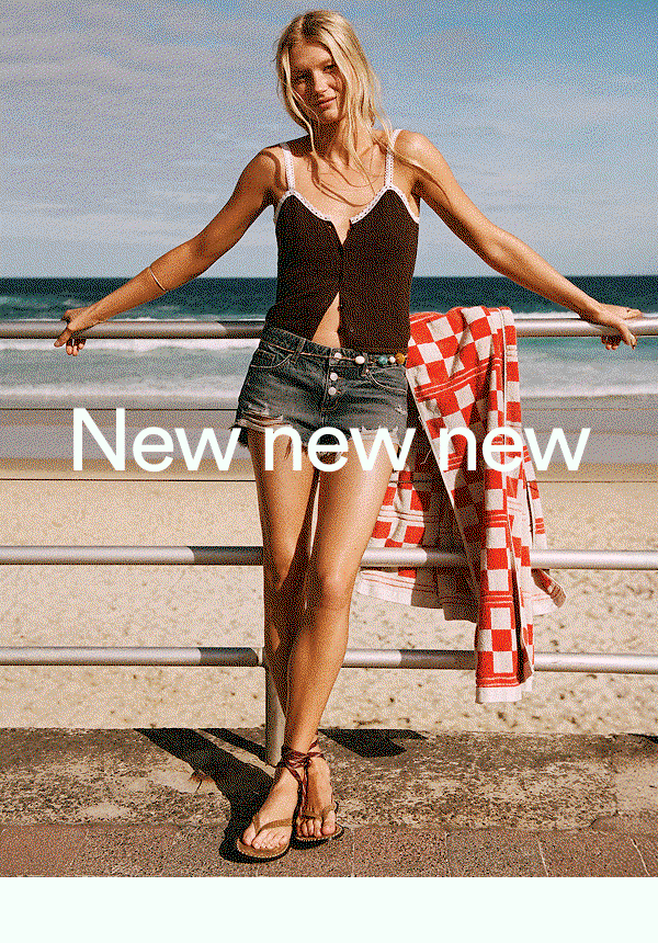 New new new - woman at beach wearing black top and denim shorts