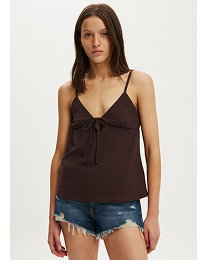 Woman wearing brown camisole and denim shorts
