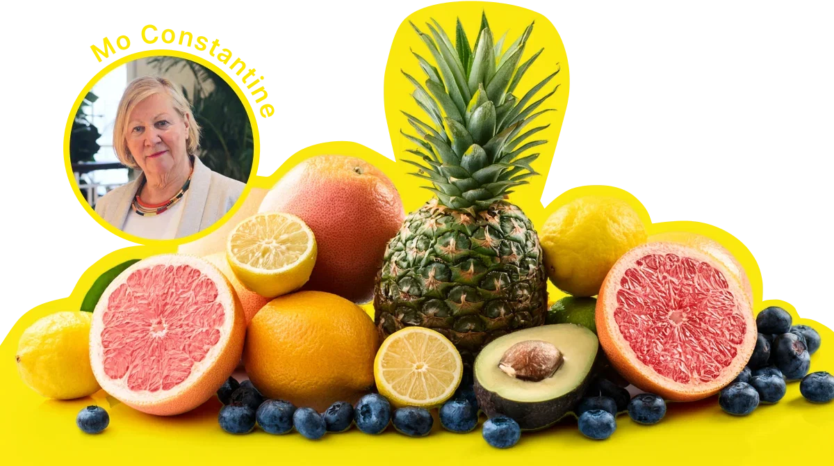 image: Mo Constantine portrait overlay on a group shot of fresh fruits such as ananas, grape fruits, avocado, lime and blueberries.