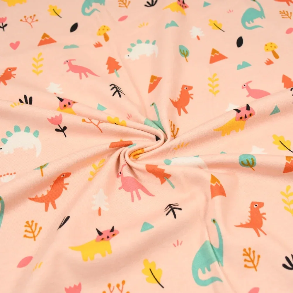 Image of Little Dino  Print Cotton Jersey Fabric Peach 150cm