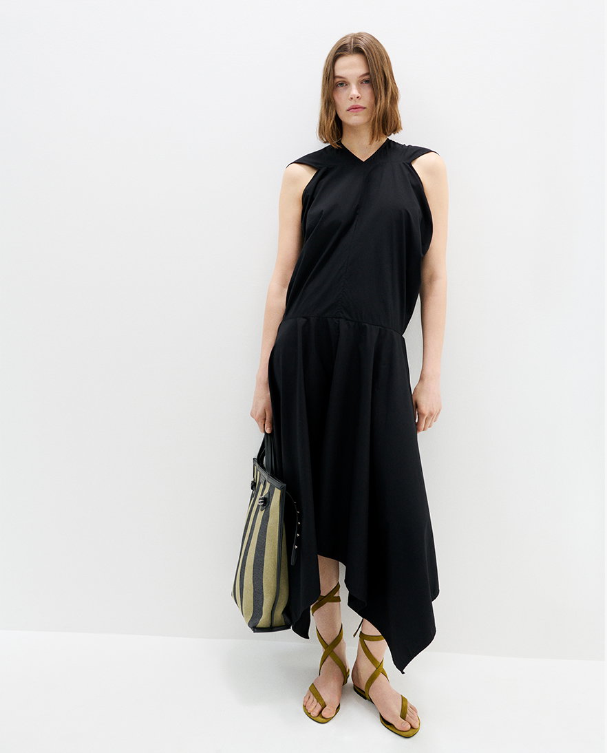 Model standing against white background wearing the Sybella Dress in Classic Cotton Shirting with the North South Days Tote in Striped Canvas in Moss/Black with the Tee Strappy Flat Sandals in Kid Suede in Pistachio 