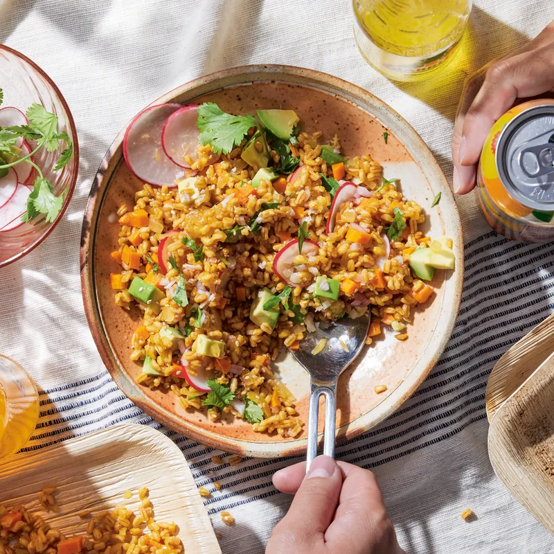 Carrot and farro salad with avocado and sliced radish.