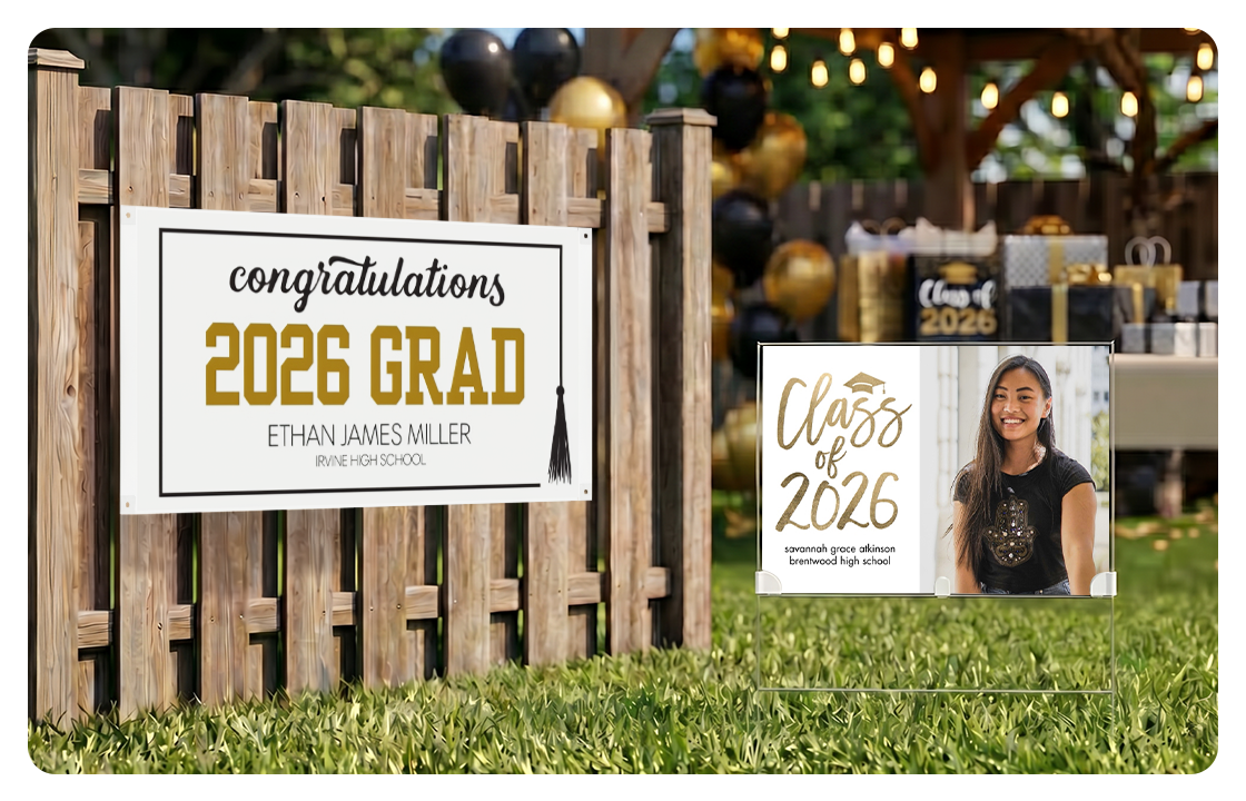 A Class of 2026 banner is displayed on a wooden fence. Next to it sits a yard sign with the graduate's picture and "Class of 2026" on it. In the background, Class of 2026 decorations and party favors are set up for the celebration.