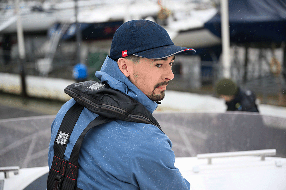 Man on a boat wearing a Storm Blue Aspect 2.0 Jacket