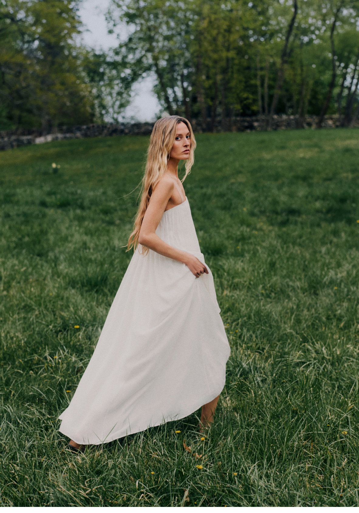 Image of a model outside in a white dress.