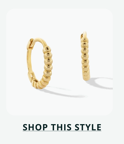 A pair of thin, gold beaded textured hoops. Click here to shop this style
