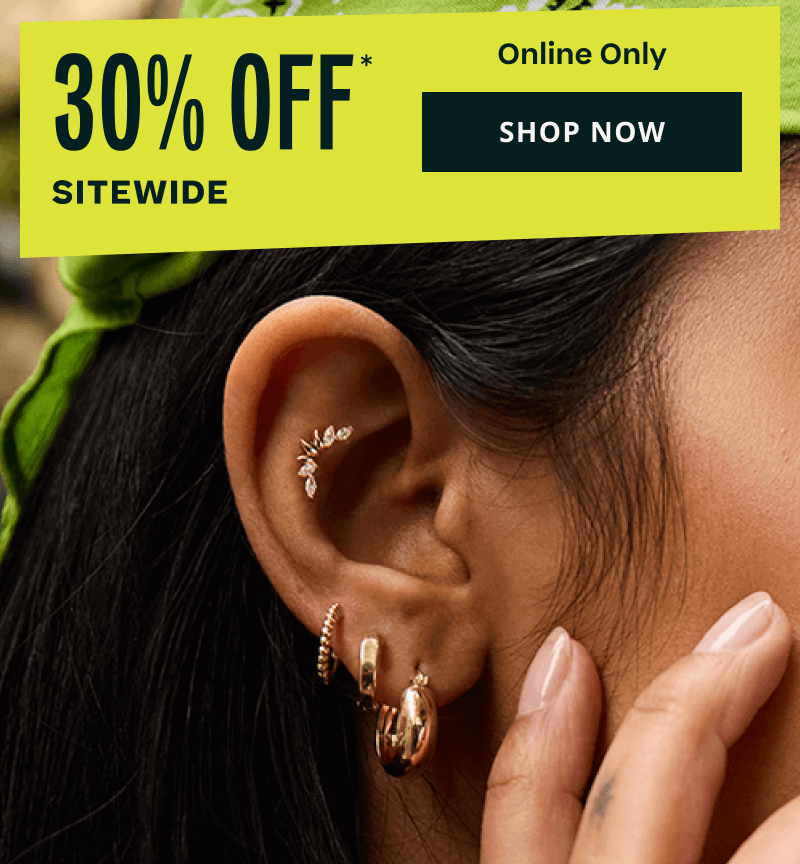 Close-up of model’s gold marquise diamond climbers, hoops & textured huggies on ear. 30% OFF Sitewide. Online. Click here to shop now