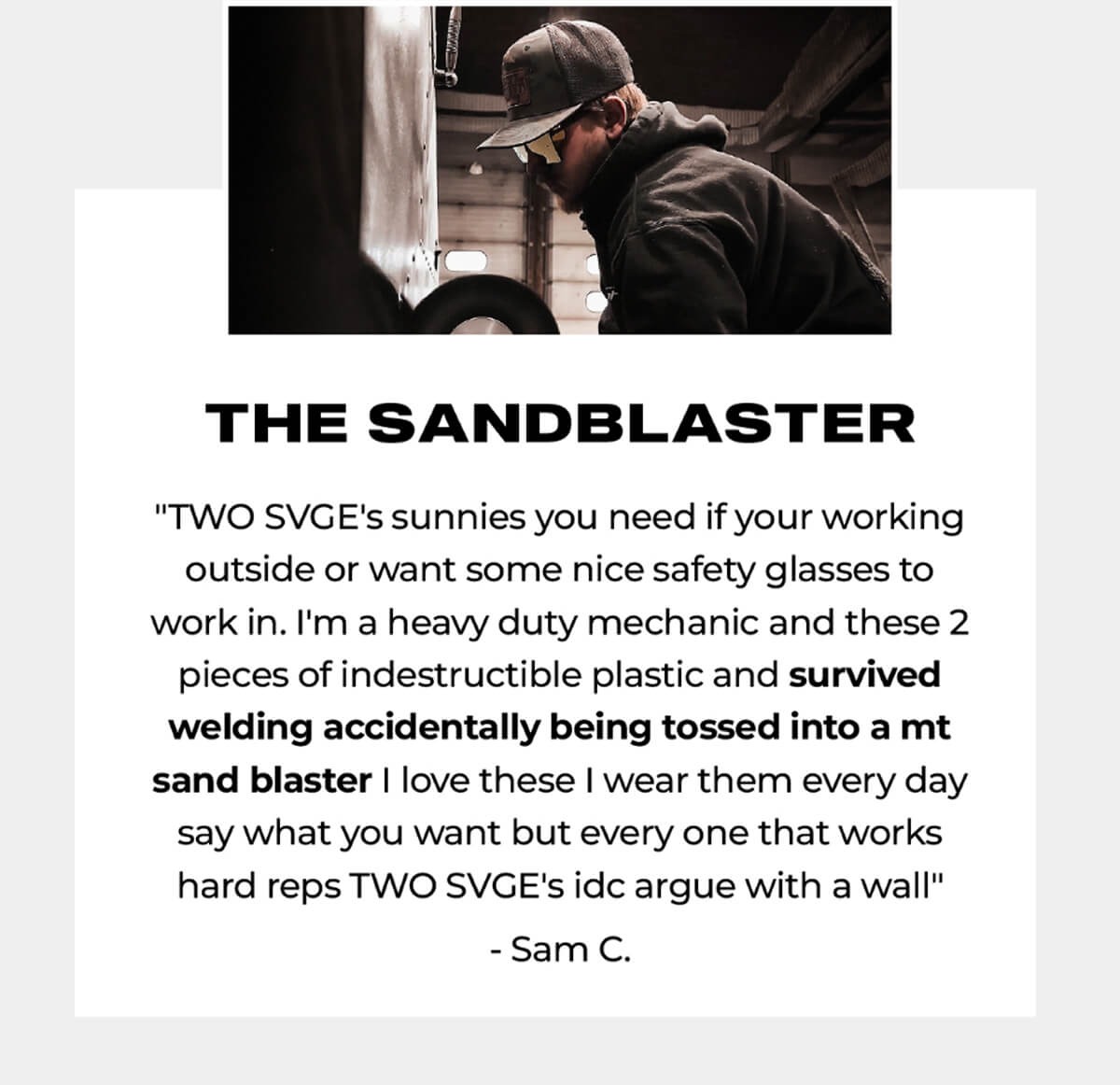Person in baseball cap and dark clothing working with industrial equipment in workshop setting