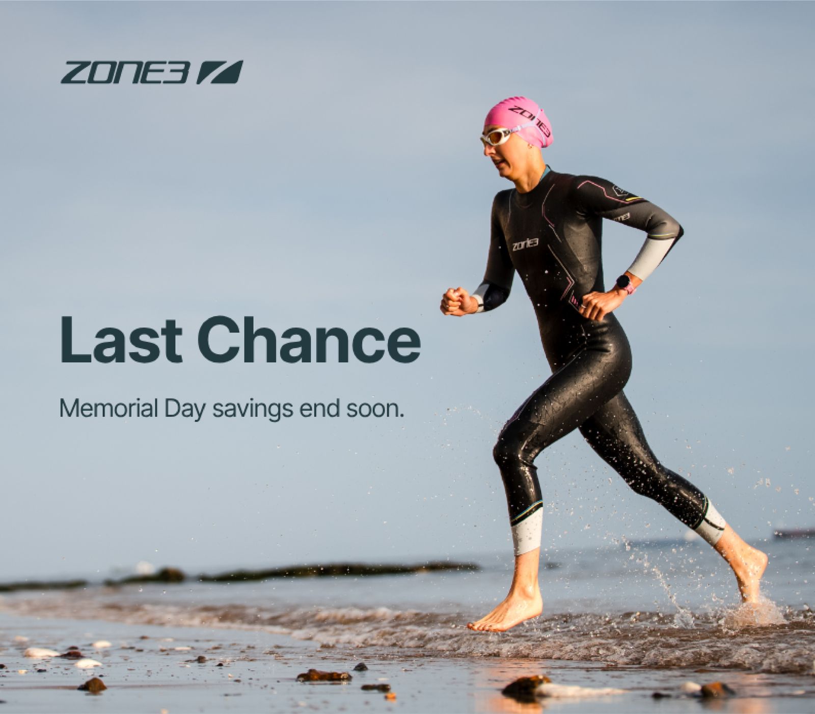 Athletes wearing Zone3 Wetsuit running out of the water