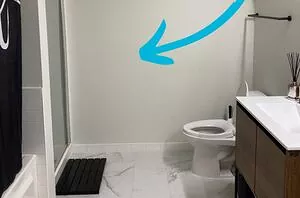 She hangs a single strip of wallpaper right next to her toilet for this stunning bathroom makeover