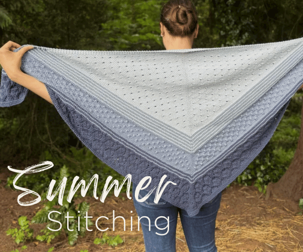woman holding a knit shawl