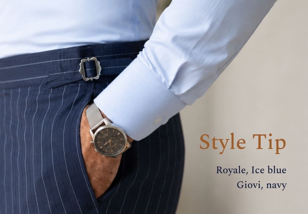 business man in ice blue dress shirt with hand in striped navy suit trouser pocket