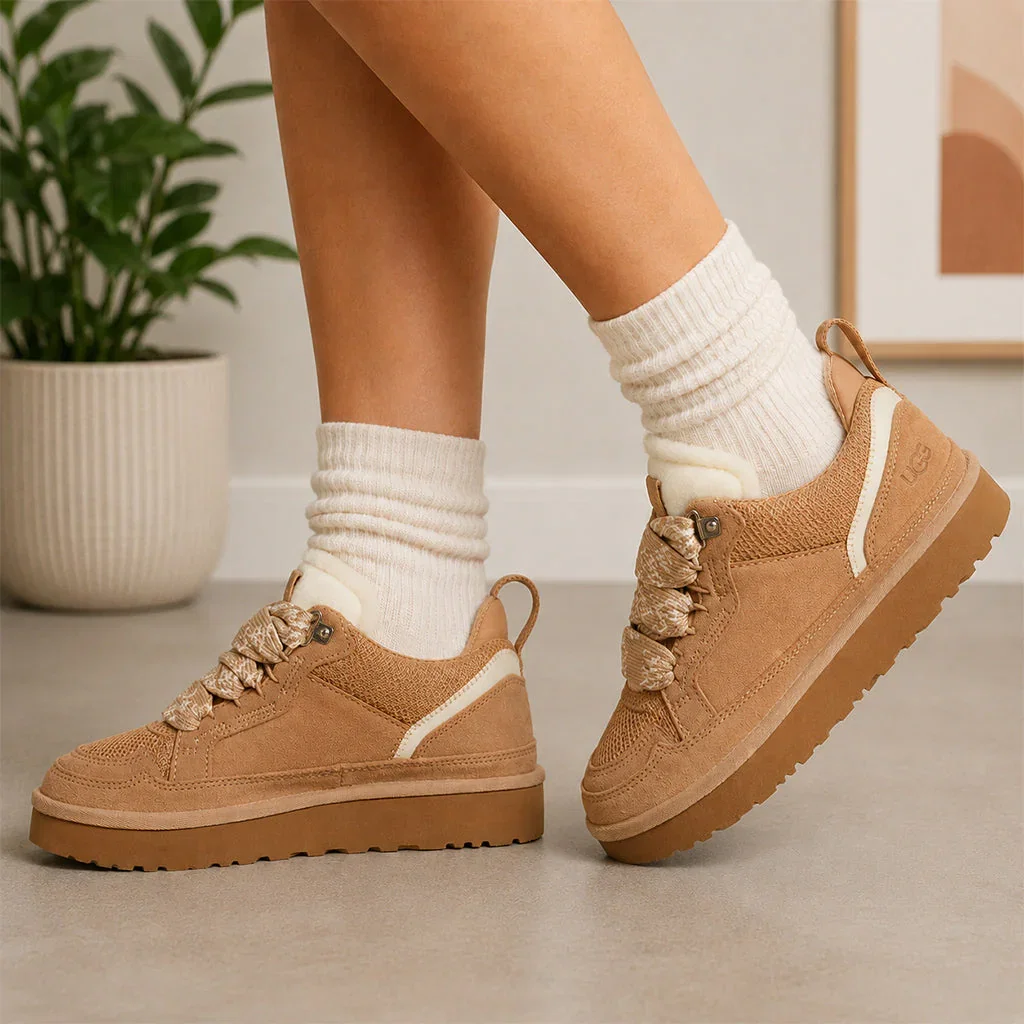 Woman wearing cream ribbed socks and tan suede platform hiking boots with chunky lug soles in modern home setting.