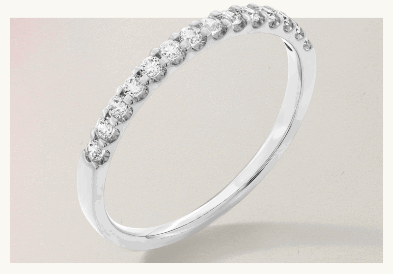 Silver-set ring with circle-cut shaped diamonds wrapped across top half of band.
