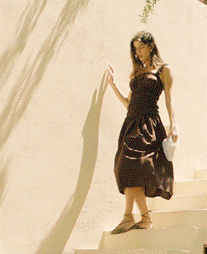 GIF of woman walking down stairs wearing Pure Cotton Shirred Midi Waisted Dress in Chocolate