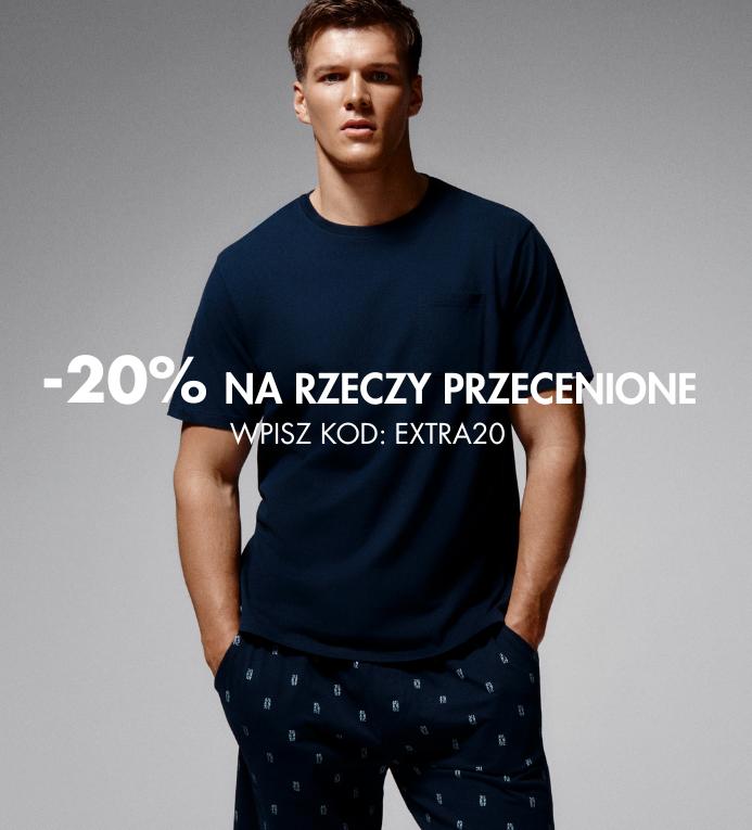 Male model in a navy t-shirt and patterned navy trousers with promotional text overlay: “-20% on sale items. Enter code: EXTRA20”
