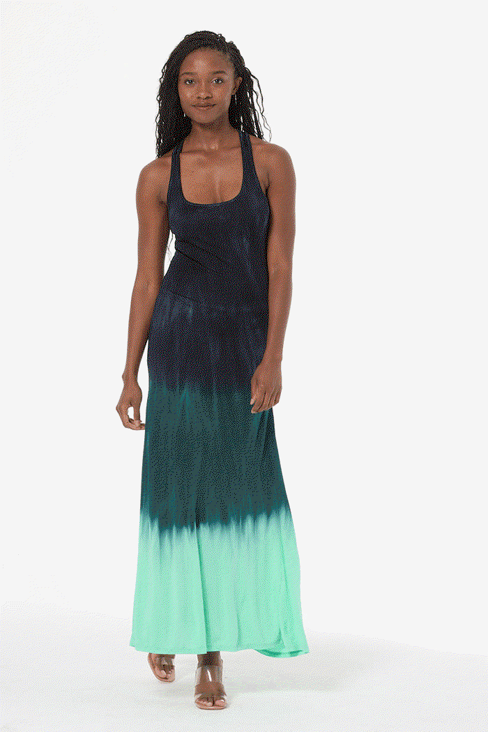 Woman wearing a teal ombre dress with a white background