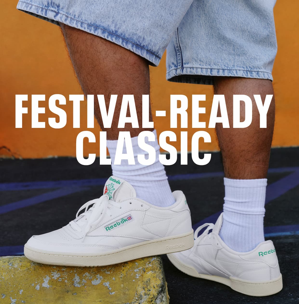 Close-up of white Club C 85 Vintage shoes with green details worn outdoors. Text reads: “FESTIVAL-READY CLASSIC.”