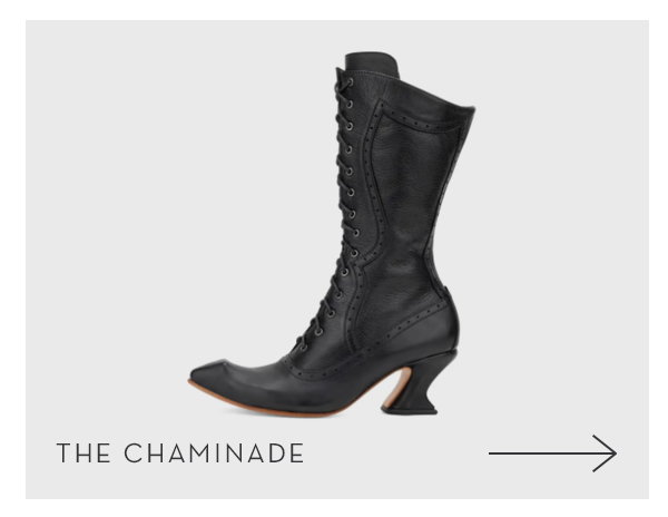 A tall black, lace-up vintage-style boot with a pointed toe