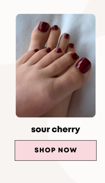 Feet with deep burgundy red toenails against white background, labeled sour cherry