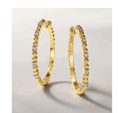 Yellow gold diamond hoop earrings with textured design.