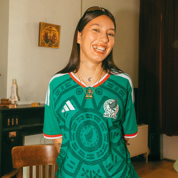 girl in adidas mexico football jersey smiling