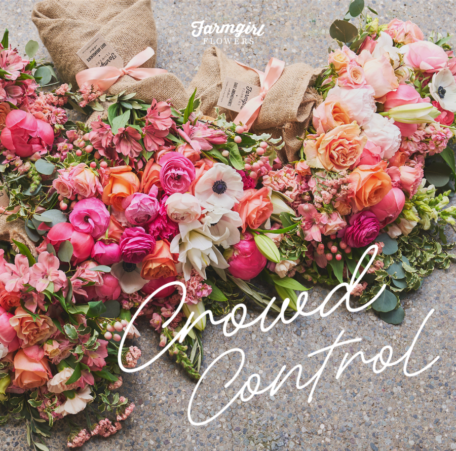 Farmgirl Flowers campaign image showing several colorful burlap-wrapped bouquets with pink, coral, peach, white, and green flowers arranged across a gray surface. The Farmgirl Flowers logo appears near the top, with the words “Crowd Control” written in large white script across the flowers.