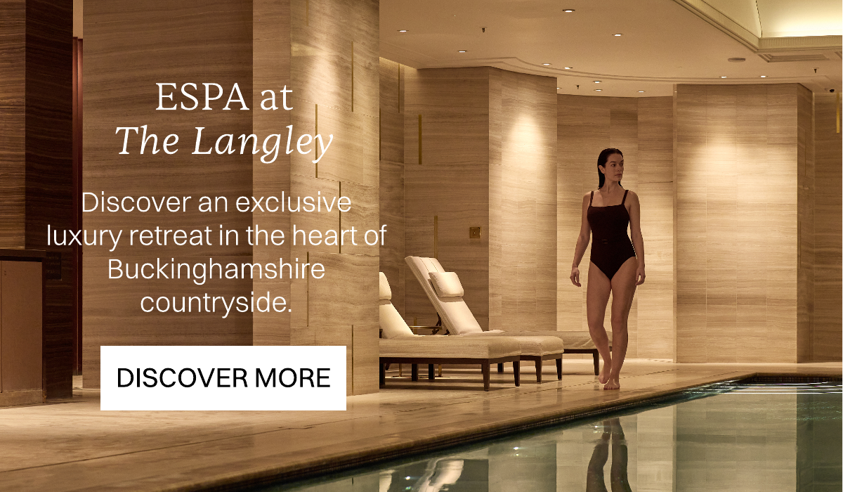 The Langley, Discover an exclusive luxury retreat in the heart of Iver's countryside. DIscover More. Image of model walking by the side of a spa infoor pool