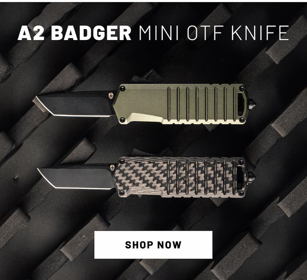 A2 Badger Mini Automatic OTF Knife placed in dark tactical background.